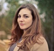 Closeup Photo of Woman With Brown Coat and Gray Top