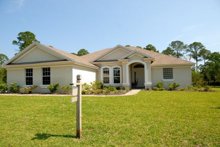 White and Brown Concrete Bungalow Under Clear Blue Sky